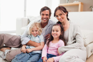 Family Relaxing On A Sofa In A Living Room