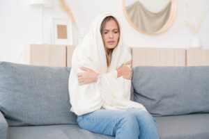 Person Wrapped In Blanket On Couch